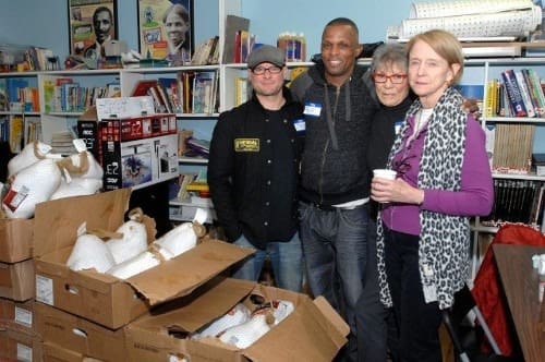 People pose with food donations.