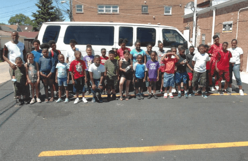 Group of kids and a van